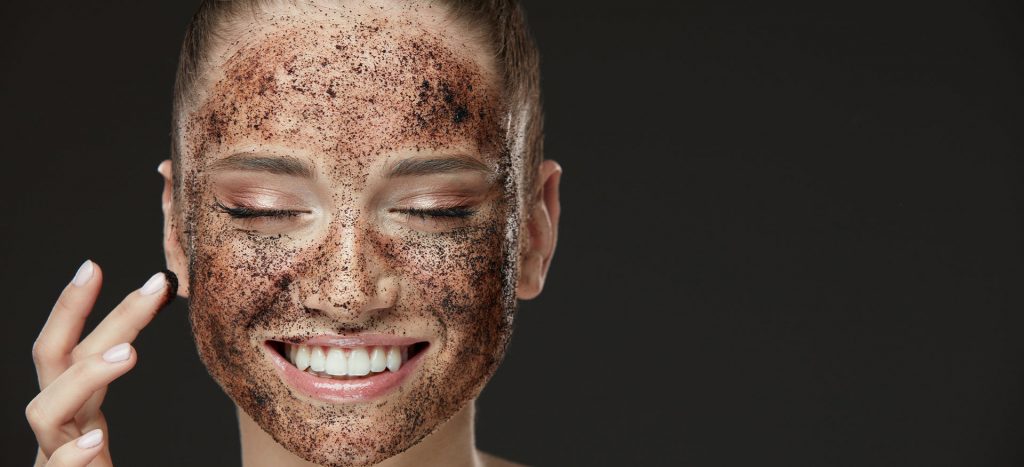 Girl using face scrub 