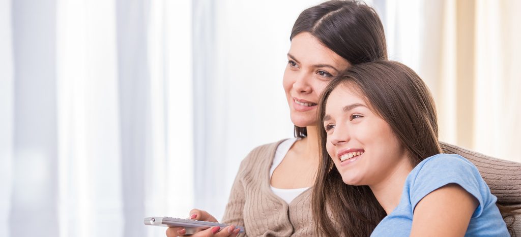 Mother and Daughter Watching TV Show